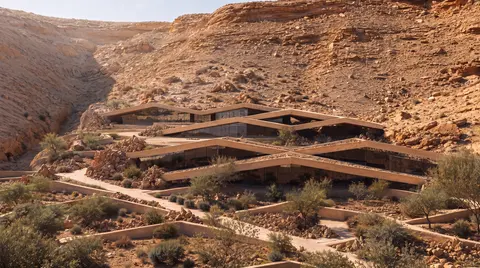 Updated visualisation of The Bedouin Retreat, with terraced roofs and planted courtyards within the rocky wadi landscape